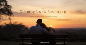 A couple sitting on a bench, embracing, and watching a serene sunset over a landscape.
